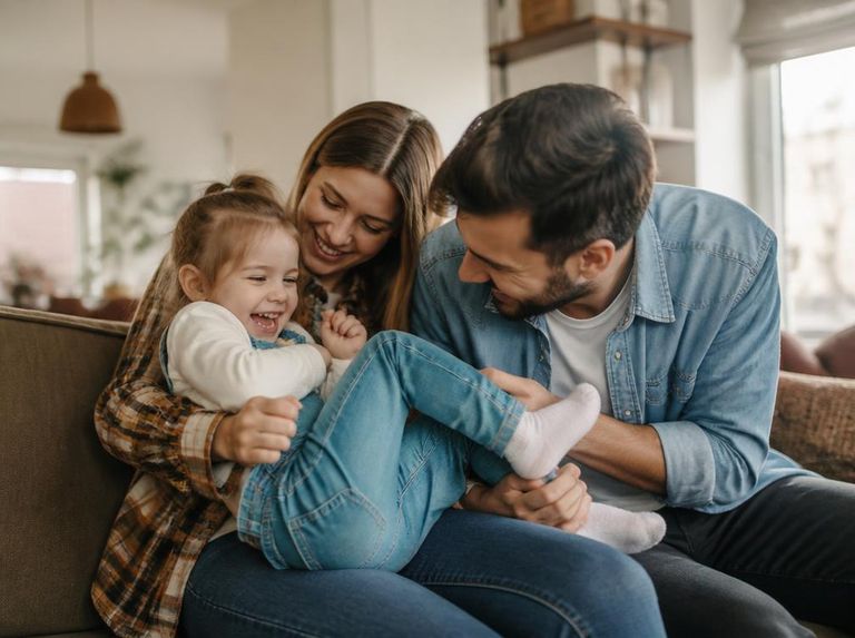 Parents sharing a playful moment with their young child at home